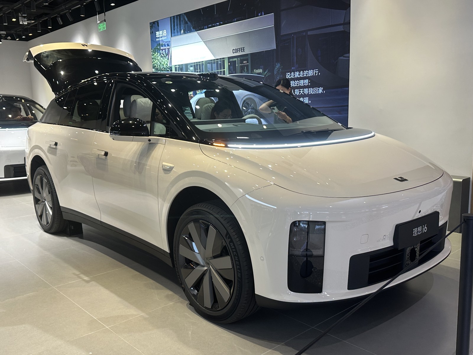 White Li Auto i6 electric SUV on display in a showroom