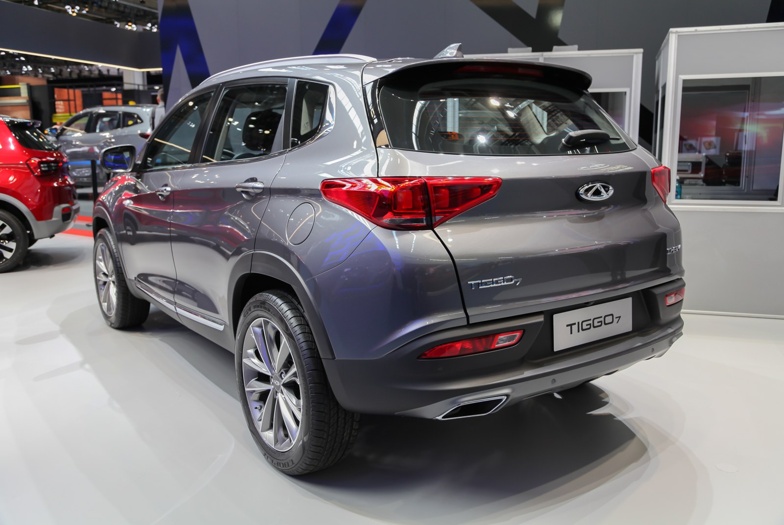 Grey Chery Tiggo 7 SUV shown from the rear at a motor show