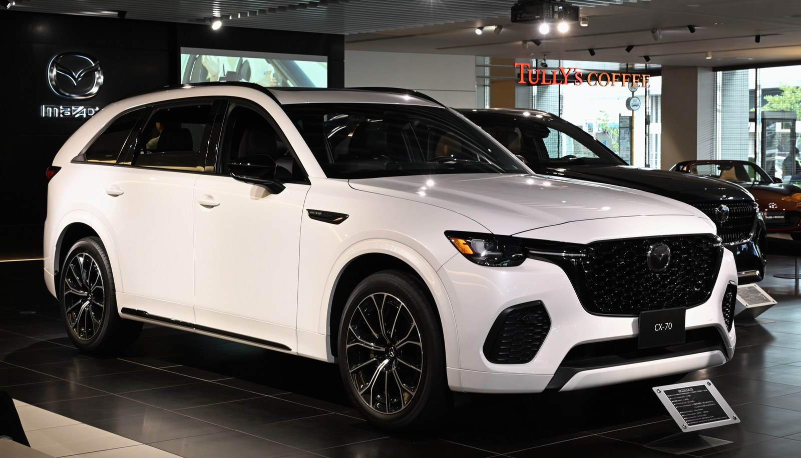 White Mazda CX-70 large SUV on display in a showroom